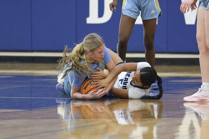 Joliet Catholic’s Emma Napier forces the jump ball against Reavis in the Peotone Blue Devils Holiday Classic championship game on Monday, Dec. 29, 2025 in Peotone.