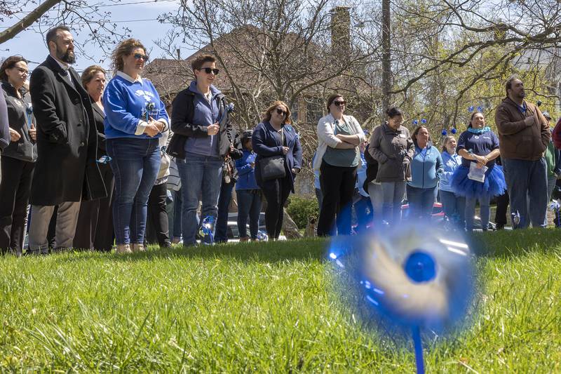 A pinwheel spins in the wind as supporters gather outside of the Old Lee County Courthouse Friday, April 19, 2024 for Hands Around the Courthouse, an event meant to bring awareness to child abuse.