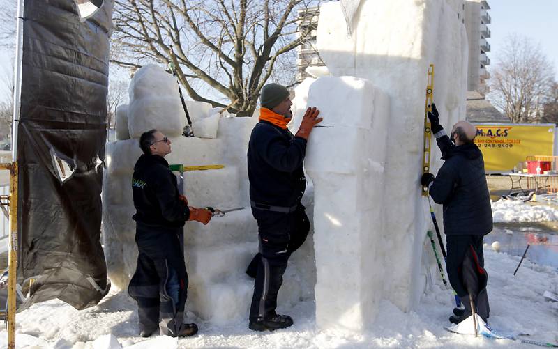Wisconsin snow carvers Mike Lechtenberg, Joshua Jakubowski, and Bob Lechtenberg work on their sculpture “Creativity Come To Life” on Thursday., Jan. 30, 2025, Snow carvers have started carving their 15 massive snow sculptures for America’s Snow Sculpting Invitational during Winterfest in Lake Geneva. Winterfest, runs through Feb, 2, 2025. The warm and rainy weather has slowed down the carving of the snow.