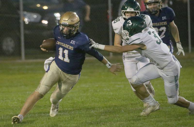 Marquette quarterback Anthony Couch gets around St. Bede players Stuart McGunnigal and Brody Burris during a run on Friday, Sept. 26, 2025 at Gould Stadium in Ottawa.