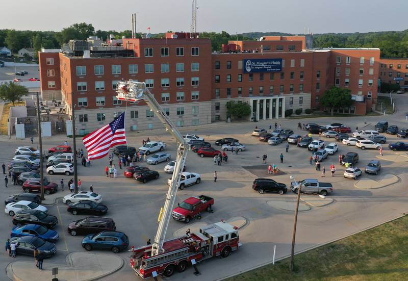 The Spring Valley Fire Department raise a flag to honor healthcare workers during a gathering at St. Margarets's Hospital on Friday, June 16, 2023 in Spring Valley.