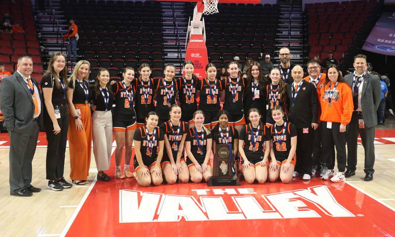 Members of the Byron girls basketball team pose with the Class 2A runner-up trophy after falling to Breese Central on Saturday, March 7, 2026 at CEFCU Arena in Normal.
