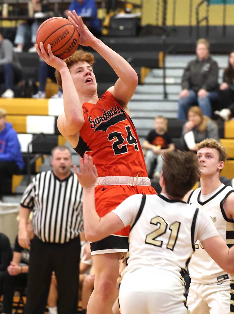 Sandwich's Dom Rome shoots over Sycamore's Ben Larry during their game Friday, Nov. 24, 2023, in the Leland G. Strombom Holiday Tournament at Sycamore High School.