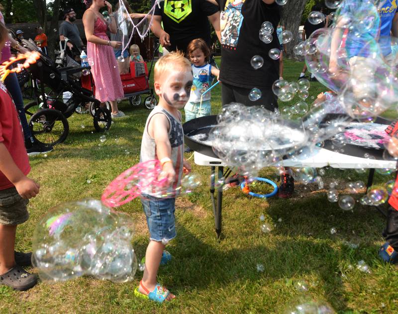 Lyncoln Engelbart. 3. of Forreston, makes a lot of bubbles at Jason Kollum's "Big Bubble Time' bubble event at Ben Miller Park during German Valley Days on Saturday, July 15, 2023.