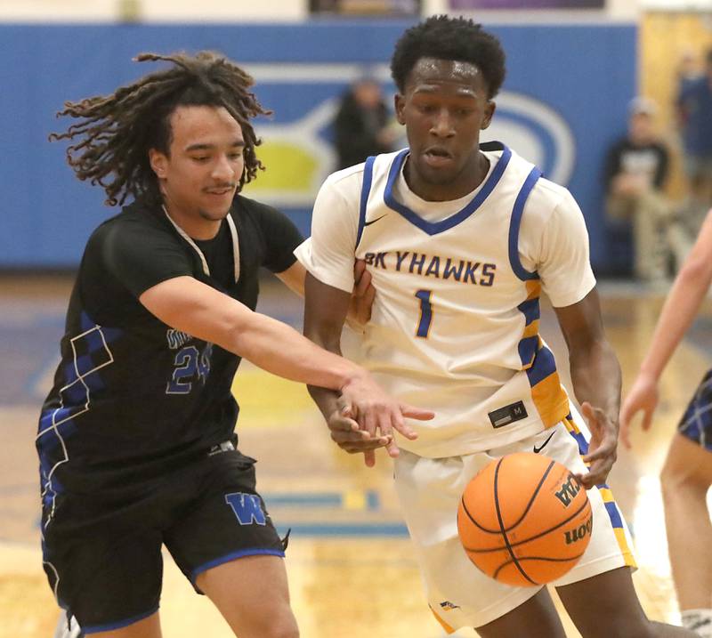 Woodstock's JJ Stokes knocks the ball away from Johnsburg's Jarrel Albea during a Kishwaukee River Conference boys basketball game on Friday, February. 13, 2026, at Johnsburg High School.