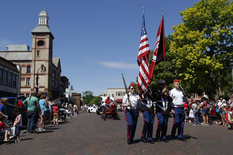 Members of the Marine Corps League cary the American Flag around the Woodstock Square during the Woodstock VFW Post 5040 City Square Memorial Day Ceremony and Parade on Monday, May 29, 2023, in Woodstock.