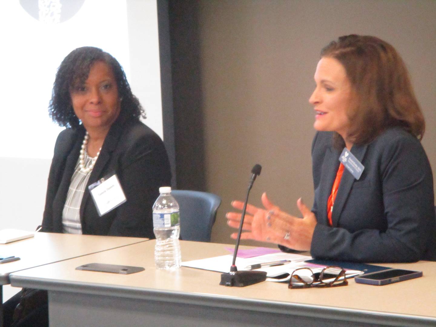 Fairmont School District Superintendent Tamela Daniels (left) listens to Valley View School District Superintendent Rachel Kinder at a presentation of the Advance Illinois report on teacher availability held Nov. 30, 2023 in Joliet.