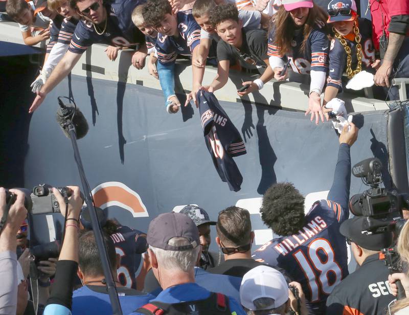 Chicago Bears quarterback Caleb Williams hi-fives fans while running back into the tunnel after defeating the Carolina Panthers on Sunday, Oct. 6, 2024 at Soldier Field in Chicago.
