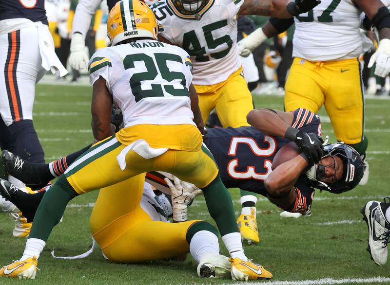 Chicago Bears running back Roschon Johnson dives past Green Bay Packers cornerback Keisean Nixon down to the goal line Sunday, Nov. 17, 2024, during their game at Soldier Field in Chicago.