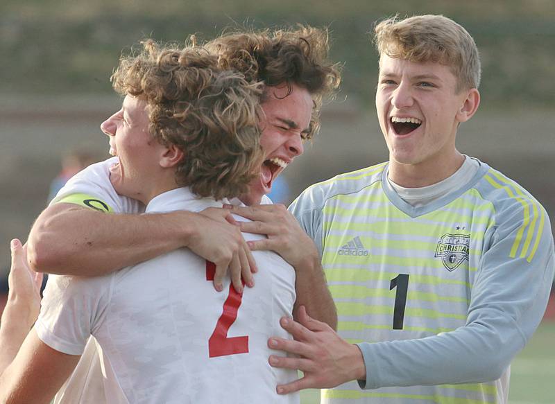 Timothy Christian players Josh McMillian (2) reacts with teammate Cameron Baker and keeper Kyle Steiner after defeating Wheaton Academy in penalty kicks by a final score of 2-1 in the Class 1A State soccer third place game on Saturday, Oct. 29, 2022 at EastSide Centre in Peoria.