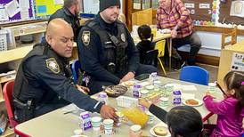 Sterling Wallace students share a bagel breakfast with local heroes