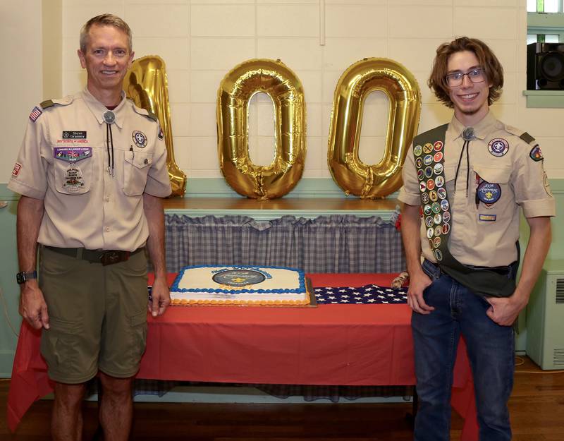 Scoutmaster Steve Gramley and Senior Patrol Leader Logan Cashburn pose with the 100th Anniversary cake at the Troop 7 100th Anniversary Celebration on Sunday, Sept. 15, 2024 at the Community Congregational Church in Elburn.