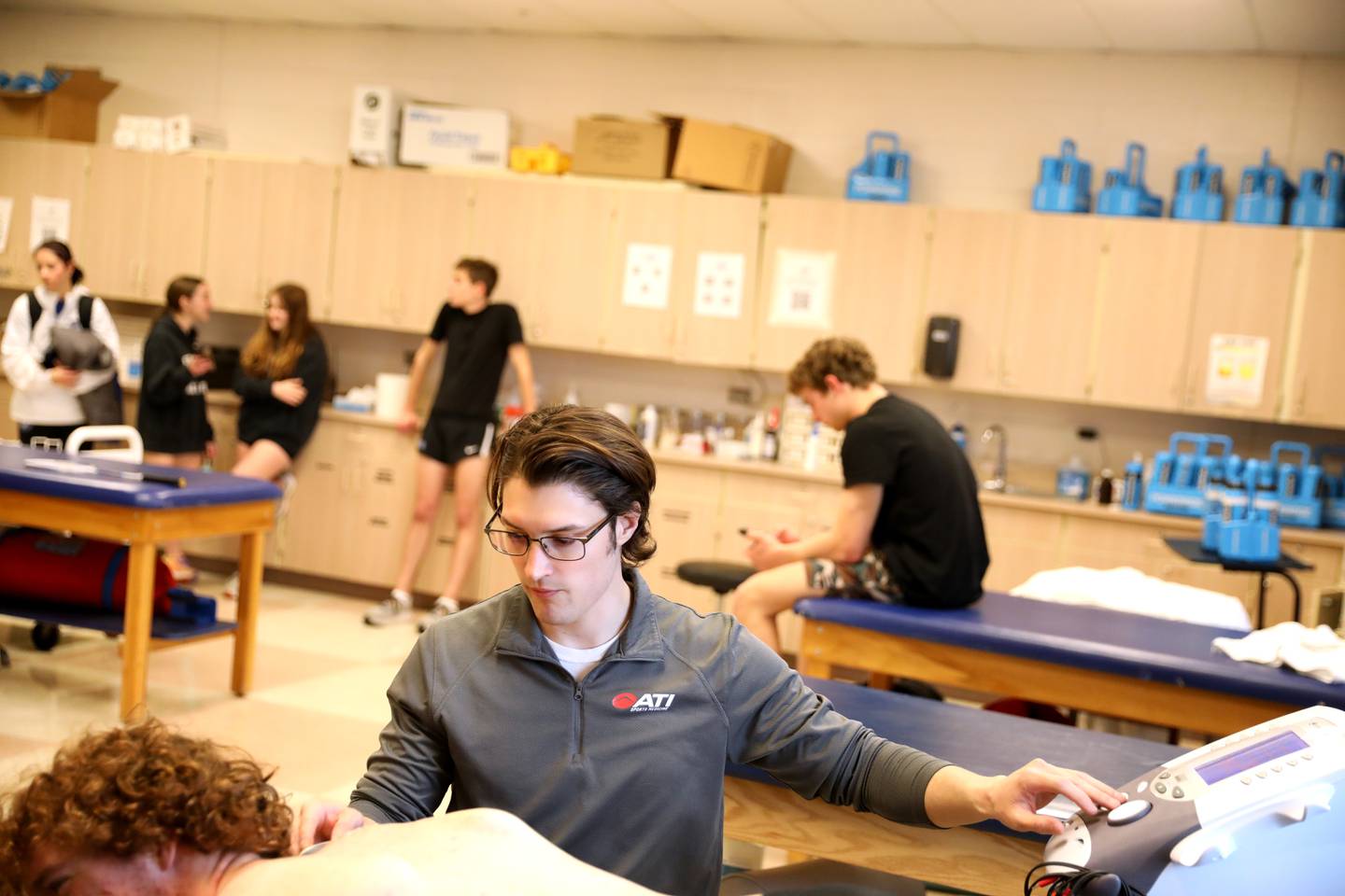 St. Charles North Athletic Trainer Zach Zinzer works with an athlete at the school.