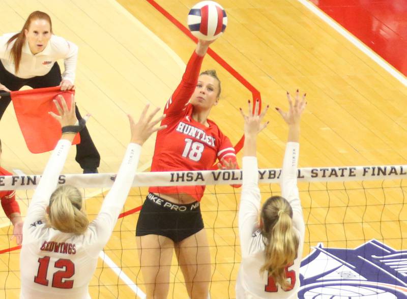 Huntley's Sienna Robertson slices a kill past Benet's Lynney Tarnow and teammate Sophia Chinetti during the Class 4A State semifinal game on Friday, Nov. 15, 2024 at CEFCU Arena in Normal.