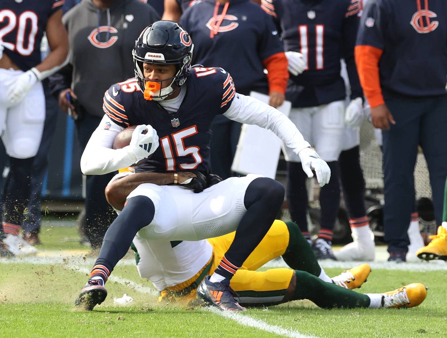 Chicago Bears wide receiver Rome Odunze picks up a few extra yards rolling on top of Green Bay Packers cornerback Keisean Nixon Sunday, Nov. 17, 2024, during their game at Soldier Field in Chicago.