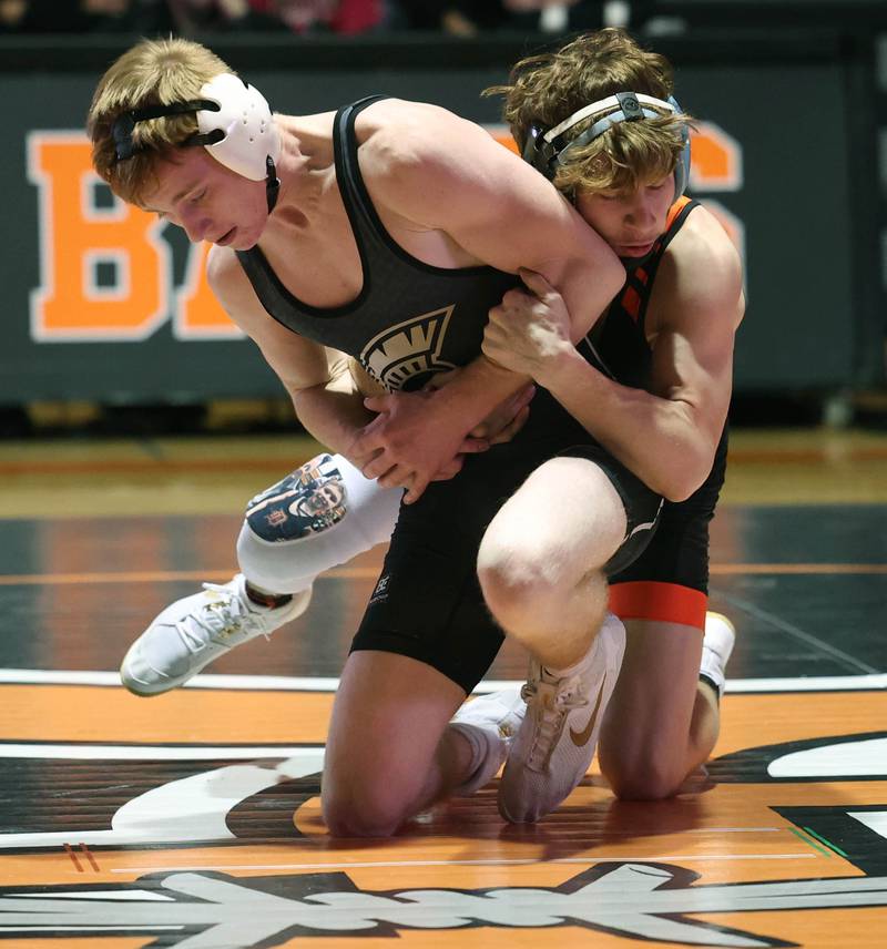 DeKalb’s Ayden Shuey (right) tries to keep the Sycamore’s Thomas Lind on the mat Friday, Jan. 17, 2025, during their 132 pound match at DeKalb High School.