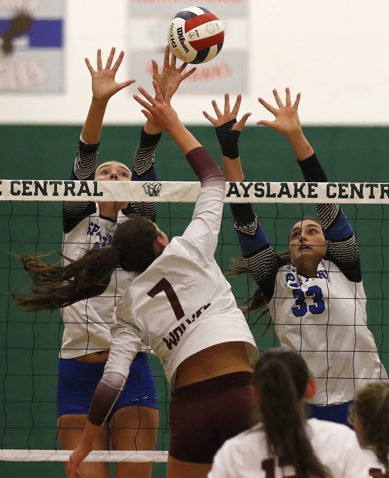 St. Francis' Addy Horner (left) and Emma Delaney (right) try to block the hit Prairie Ridge's Maizy Agnello during the IHSA Class 3A Grayslake Central Supersectional volleyball match on Monday, Nov. 11, 2024, at Grayslake Central High School.