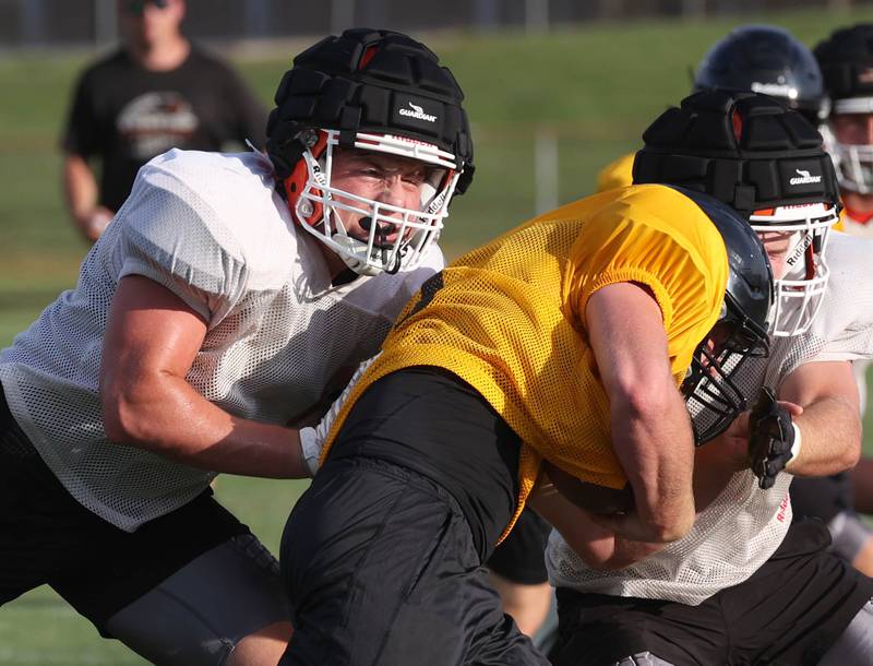 Byron’s Caden Considine pursues a Lena-Winslow ball carrier Thursday, July 24, 2025, during a joint practice with Byron, Lena-Winslow and Sycamore at Sycamore High School.