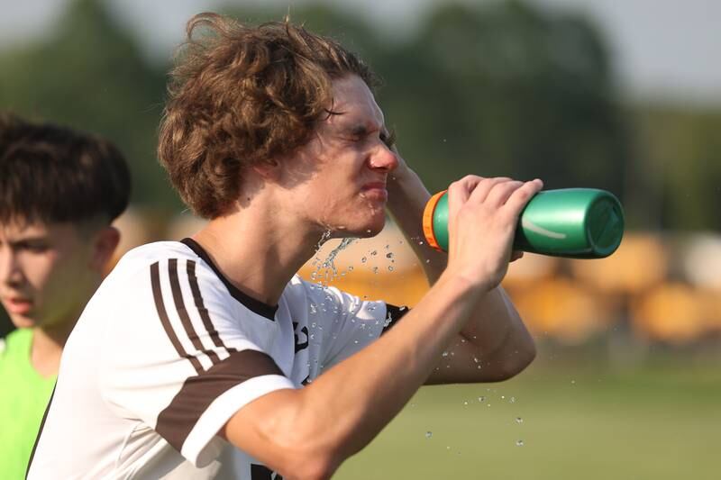 Joliet Catholic's Liam Connolly cools down during a break in action against Providence on Aug. 21, 2023 in New Lenox.