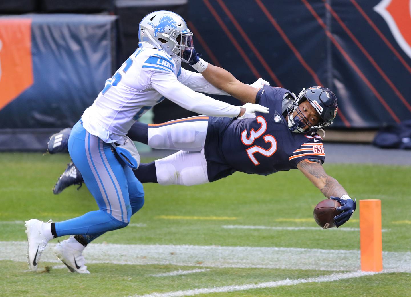 Chicago Bears running back David Montgomery (32) dives for the pylon for a touchdown ahead of Detroit Lions strong safety Duron Harmon (26) during their game Sunday at Soldier Field in Chicago.