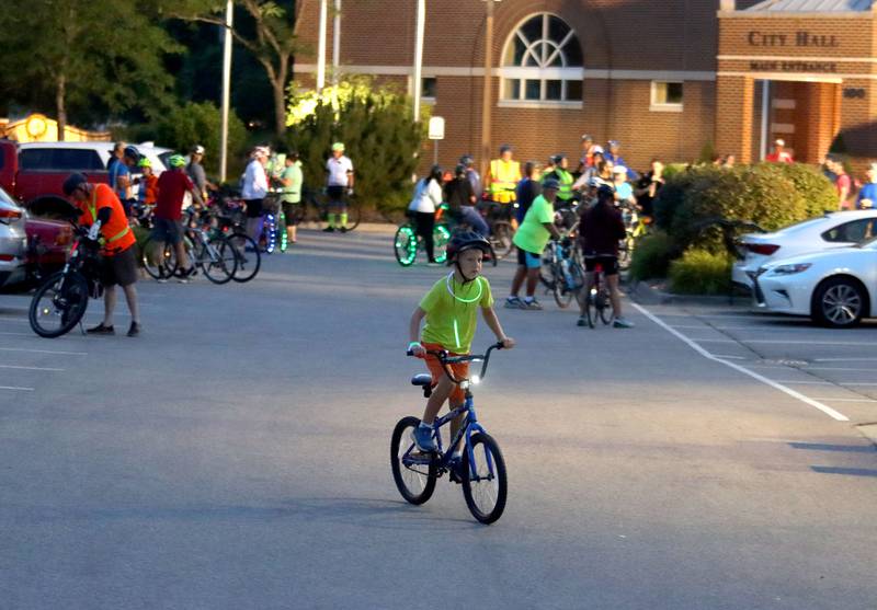 Riders prepare for the Raue Center for the Arts Night Owl Bike Ride in Crystal Lake on Saturday, August 2, 2025.