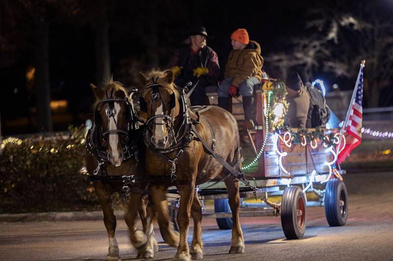 Dan Eads, owner and operator of Circle E Enterprises, drives the team of horses through Centennial Park on Sunday, Nov. 27, 2022.