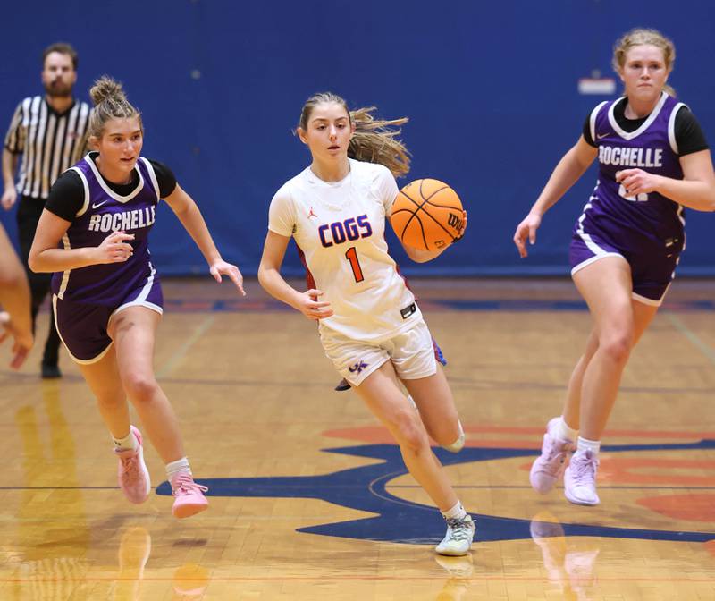 Genoa-Kingston's Presley Meyer brings the ball up court ahead of two Rochelle defenders during their game Monday, Dec. 16, 2024, at Genoa-Kingston High School.