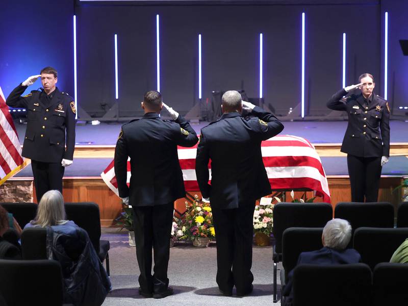 DeKalb County sheriff's deputies switch shifts guarding the casket of former DeKalb County Sheriff Roger Scott during his visitation Thursday, March 6, 2025, at Bethany Road Bible Church in DeKalb. Scott, who was the county sheriff for more than 30 years, died on February 23 at the age of 78.