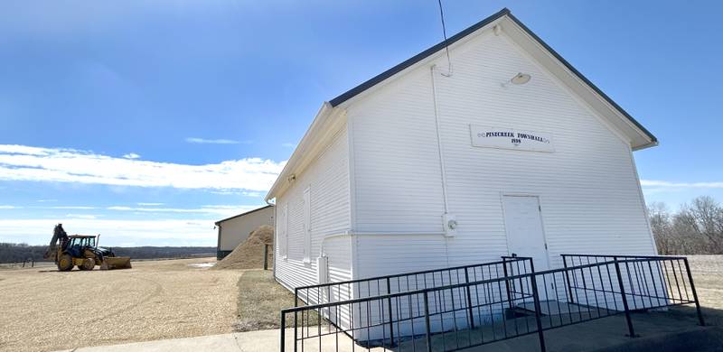 The Pine Creek Town Hall, constructed in 1898, is located on Pines Road between Oregon and Polo. It is where Pine Creek Township voters cast their ballots. In the background is some of the equipment and garage used by the township to maintain and plow township roads.
