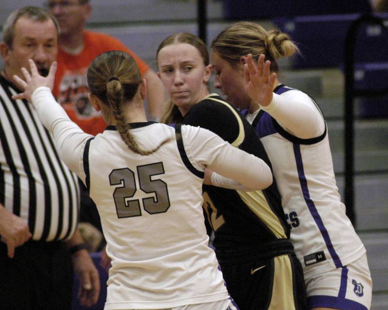 Sycamore's Sadie Lang is surrounded by Dixon's Presley Lapin and Abby Hicks. The Dixon Duchesses beat the Sycamore Spartans 55-47 in a non-conference game played at Lancaster Gym in Dixon on Saturday, December 20th, 2025.