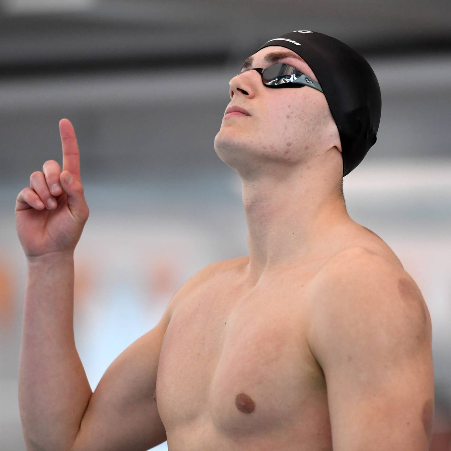 Marian Central’s Antonio Aguirre points skyward before stepping onto the starting block for the 50-yard freestyle during the boys state swimming and diving finals at the FMC Natatorium on Saturday, Feb. 28, 2026 in Westmont.