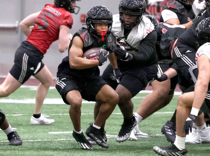 Northern Illinois running back Romelo Ware carries the ball during the first spring football practice Thursday, March 27, 2025, in the Chessick Practice Center at NIU in DeKalb.