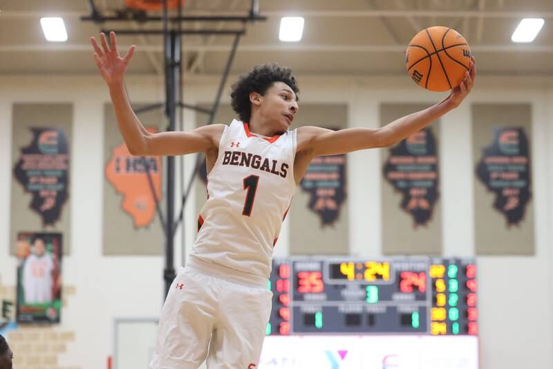 Plainfield East’s Kierre Miller pulls in a rebound against Plainfield North on Tuesday, Jan 14, 2025.