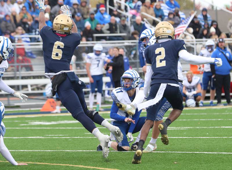 Princeton's Braden Shaw watches kicker Braylon Clevenger's kick get blocked by Central Catholic's Valshun Powe during the Class 3A playoffs on Saturday, Nov. 1, 2025 at Central Catholic High School in Bloomington.