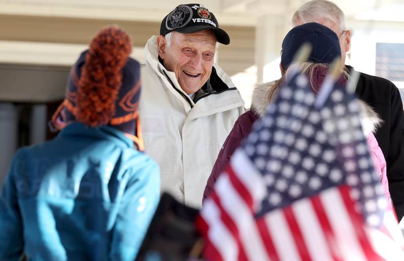 US Navy veteran Richard Korleski, 93, who served in the Korean War, smiles as he talks to members of the Kunkel family after they rode their bikes in a parade on Veterans Day,  Friday, Nov. 11, 2022, at the Grand Victorian assisted living facility in Sycamore. Sycamore resident Joann Kunkel read a story in the current Midweek that contained a quote from one of the veterans at the facility that lamented the lack of a parade. So she and her grandkids decided to have one for them.