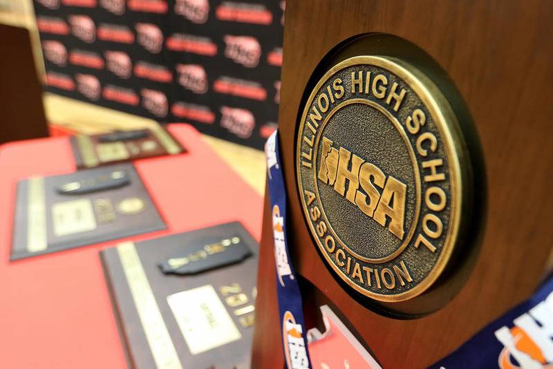 The IHSA softball state championship trophy sits on a table with the regional, sectional, and supersectional plaques won by the Huntley Red Raiders softball team as they celebrate their accolades with friends, family, and fans at Huntley High School on Monday, June 17, 2019 in Huntley.  The state championship is the first first ever earned by a Huntley team.