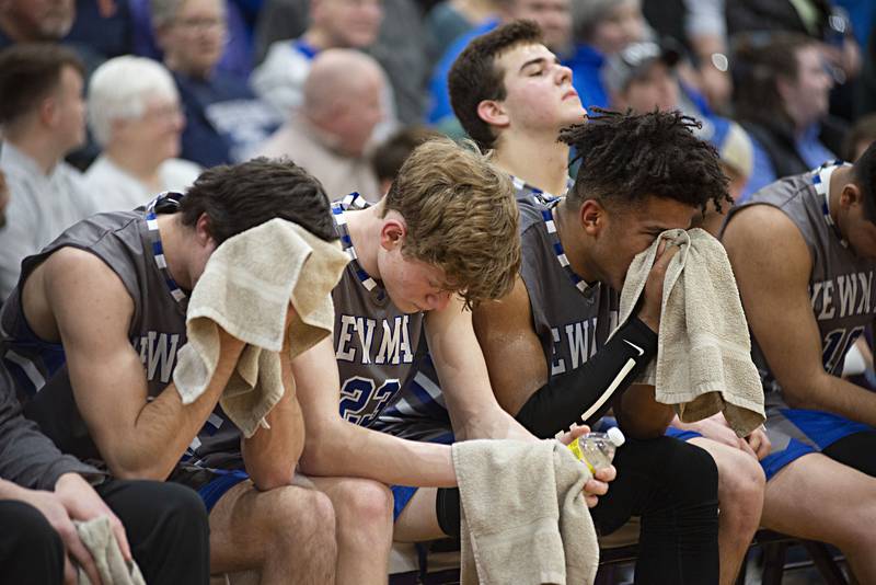 The Newman bench sits by as the final moments of their sectional final against Scales Mound ticks by Friday, March 4, 2022. The Comets lost 62-49.