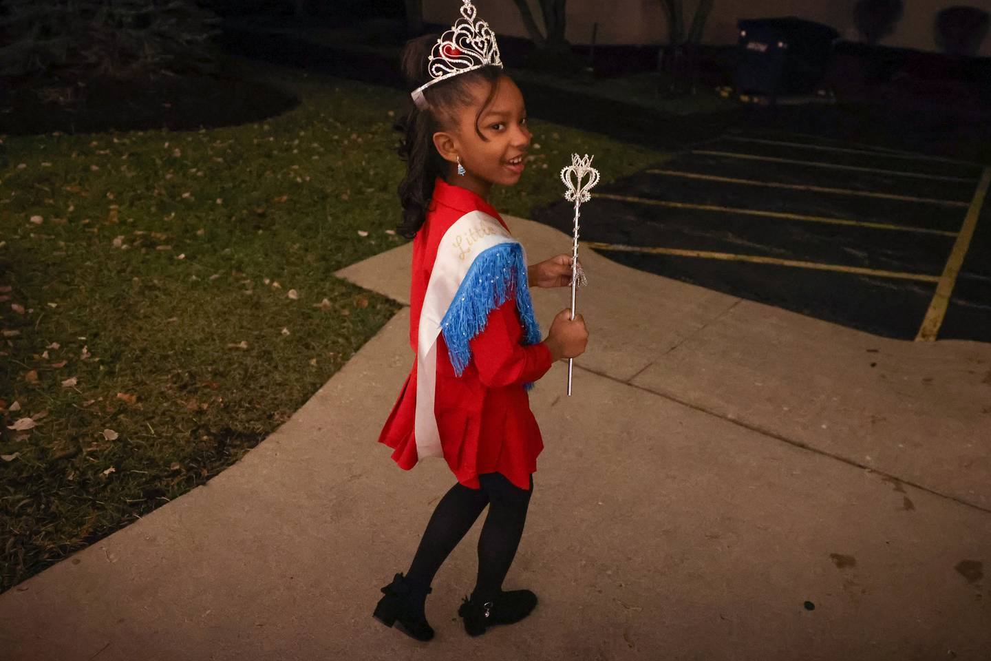 Reyna Slater, age 7, who recently won the 2023 Little Miss Black Joliet leaves a clubhouse after getting her photo taken on Tuesday, Dec 5, 2023. The pageant was an annual event until 2008 and was revived this year