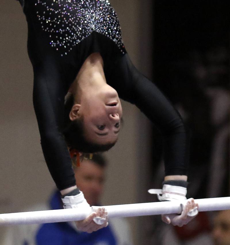 DeKalb's Annabella Simpson competes in the preliminary round of the uneven parallel bars Friday, Feb. 17, 2023, during the IHSA Girls State Final Gymnastics Meet at Palatine High School.