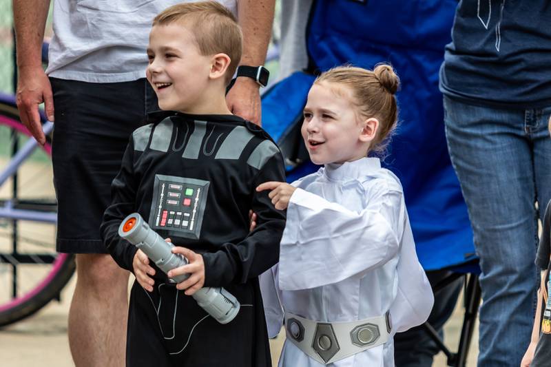Luke and Emma Carlson, of Naperville, smile as they enjoy Joliet Public Library's Star Wars Day Parade on June 7, 2025.