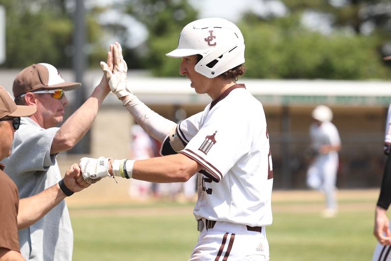 Joliet Catholic’s Jake Troyner celebrates his game ending  2 RBI in the Hilltoppers 14-4 win over Spring Valley Hall in the Class 2A Geneseo Supersectional on Monday, May 29, 2023 in Geneseo.
