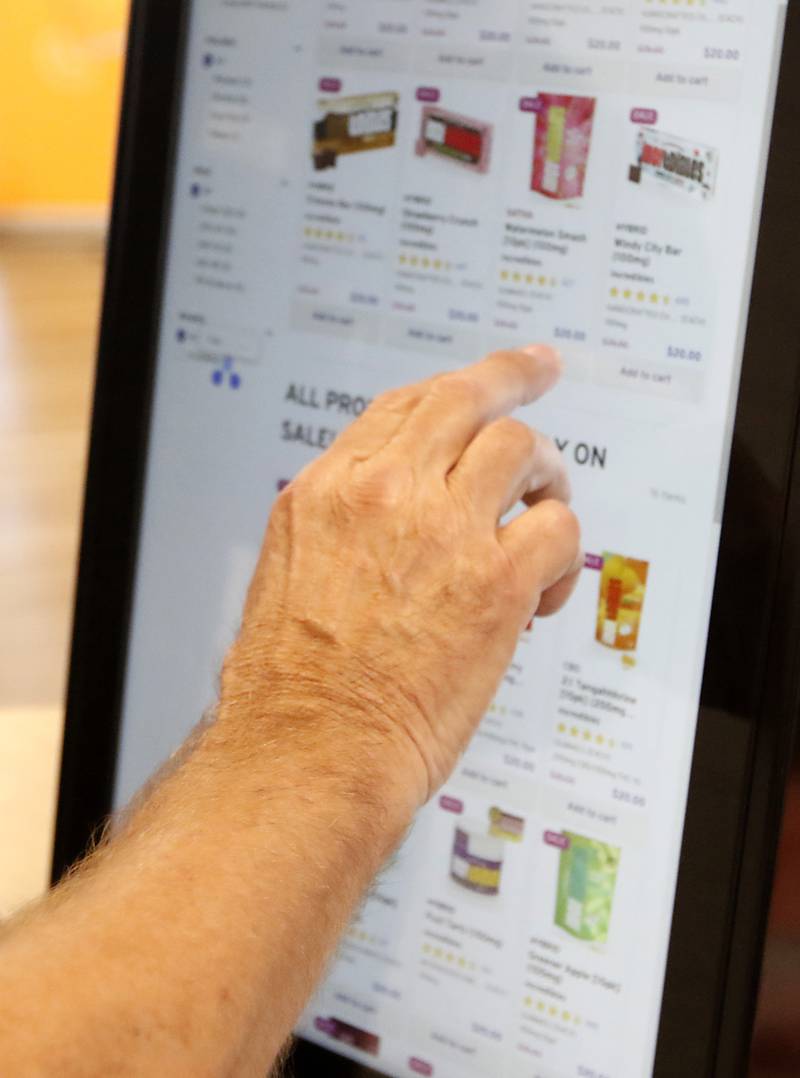 A person uses a touch screen to shop for marijuana products Thursday, July 14, 2022, at RISE, 270 North Randall Road in Lake in the Hills. Marijuana is set to grow both across the state and in McHenry County. Currently, RISE in Lake in the Hills is the lone dispensary open in the county.