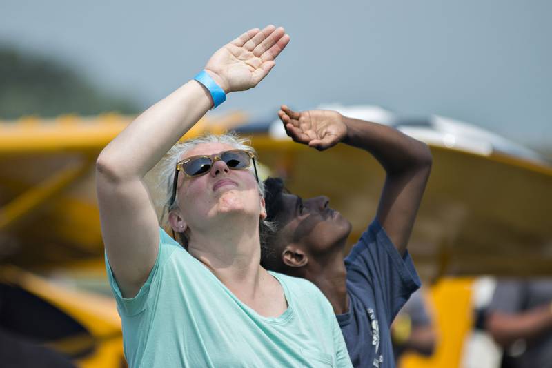 Watches gaze into the sky trying to spot the start of air show with the Misty Blues Skydiving Team on Saturday, July 24, 2021, at Whiteside County Airport near Rock Falls.