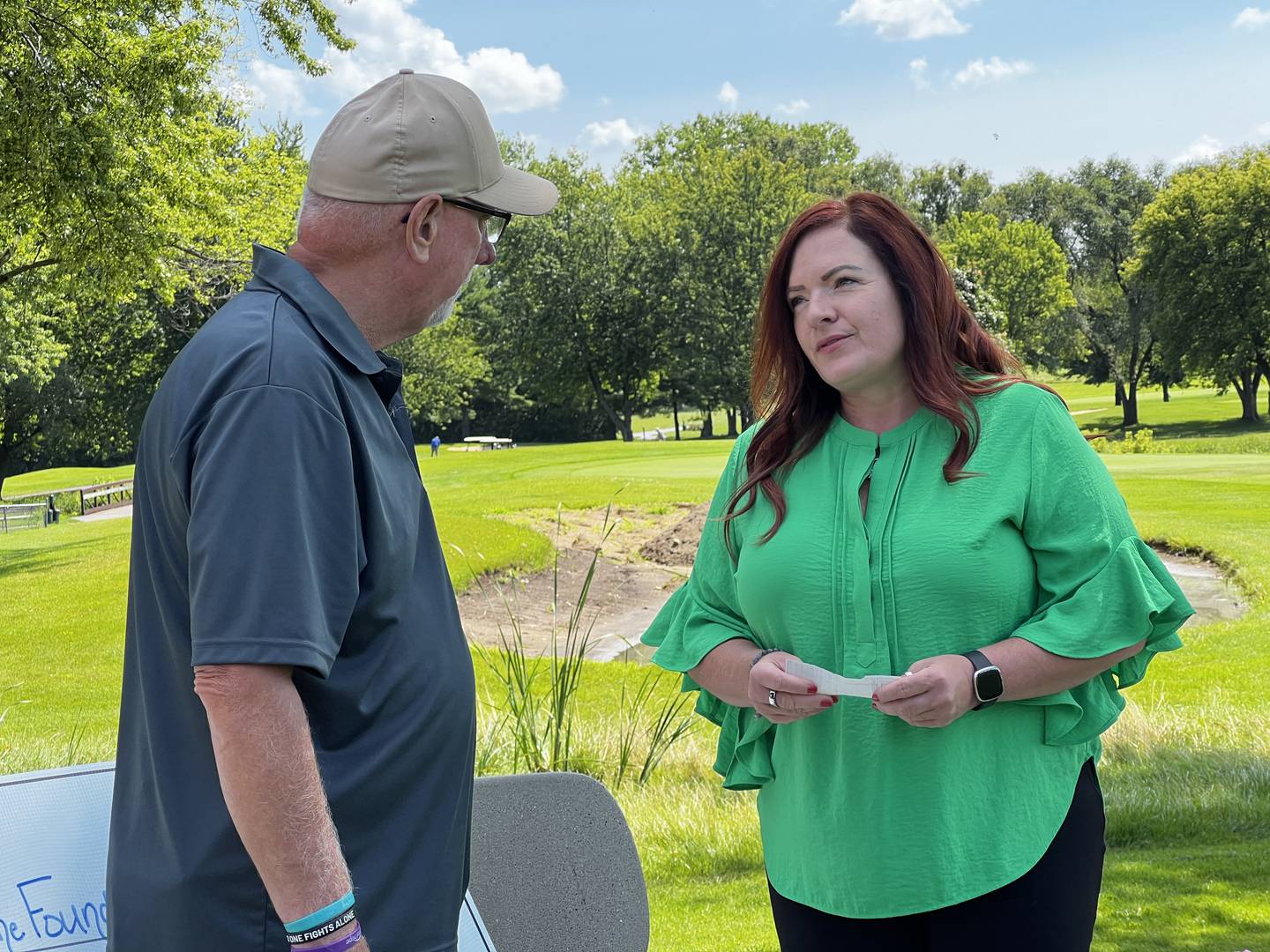 Roger Finnan gives Northwestern Medicine LivingWell Cancer Resource Center Director Angela McCrum a check for $13,000 on July 19, 2024, which he raised through a charity golf outing in honor of his late wife Shannon Finnan.