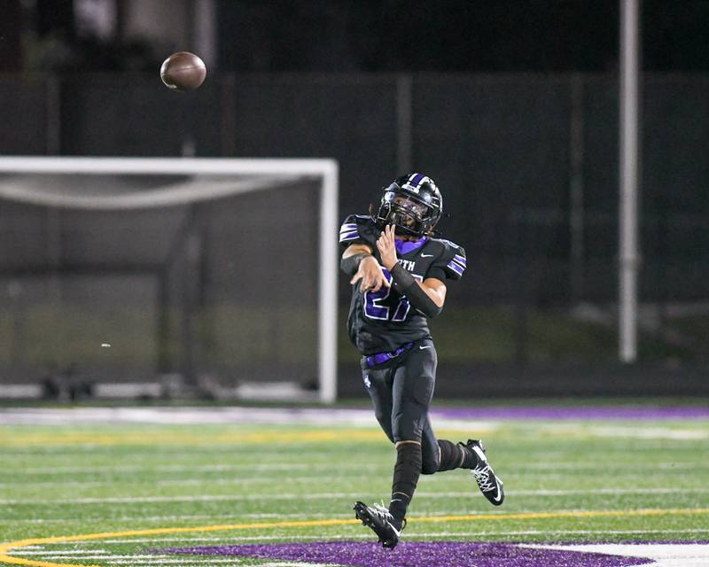 Downers Grove North's Kevin Jay Jr. (27) throws the ball on the run during the game on Friday Sept. 12, 2025, while taking on Hinsdale Central held at Downers Grove North High School.
