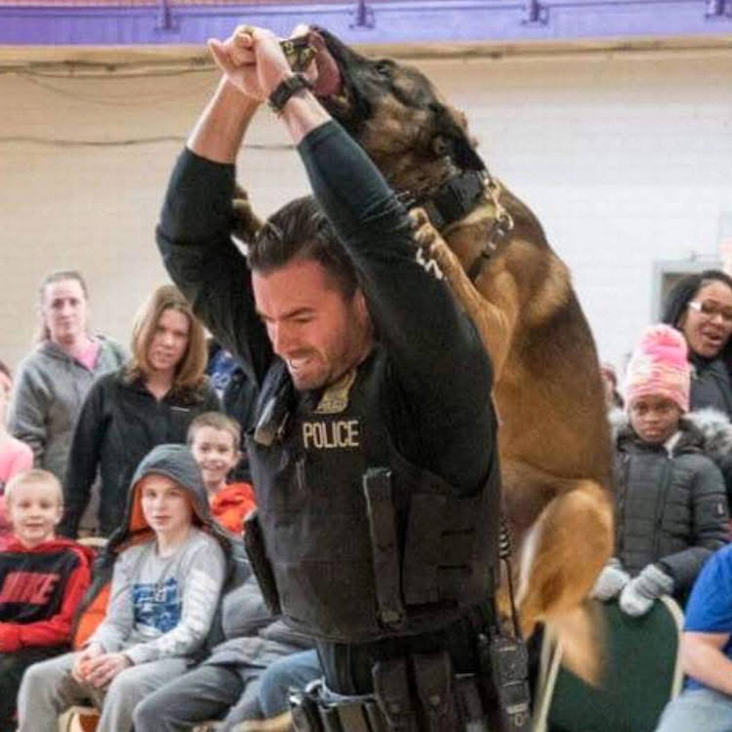 Bourbonnais Police Sgt. Dave Herberger performs commands with his K-9 partner Athos as part of a school demonstration.