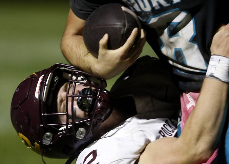 Richmond-Burton's Bryce Kowall tackles Woodstock North's Michael Pintor for a lose during a Kishwaukee River Conference football game on Friday, Oct. 10, 2025, at Woodstock North High School.