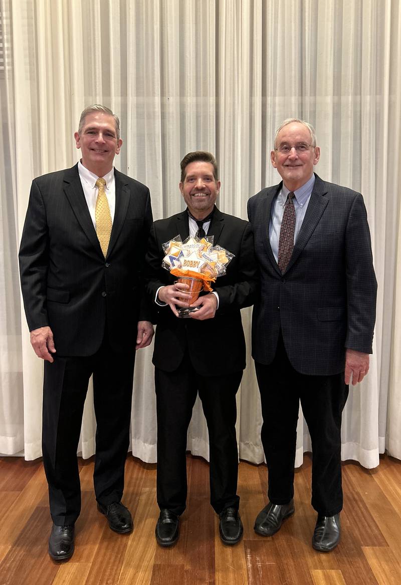 Bobby Hilsabeck, center, with Marklund President and CEO Gil Fonger and Board Member Frank Murnane Jr.