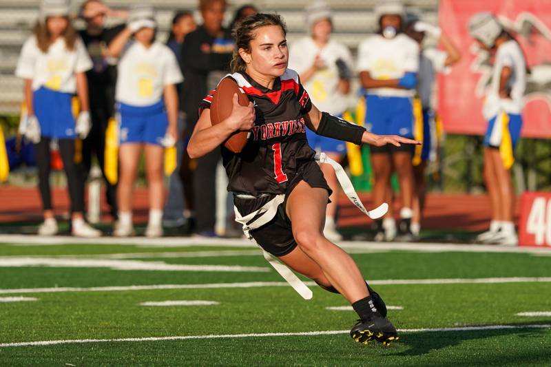 Yorkville's Gabby Vega (1) carries the ball against Joliet Central during a flag football game at Yorkville High School on Monday, Sep 23, 2024.