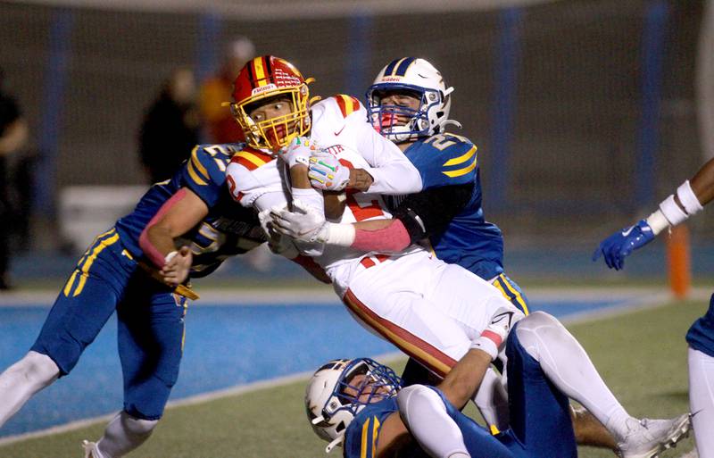 Batavia’s Isaiah Brown holds onto the ball during a game on Friday, Sept. 27, 2024 at Wheaton North.